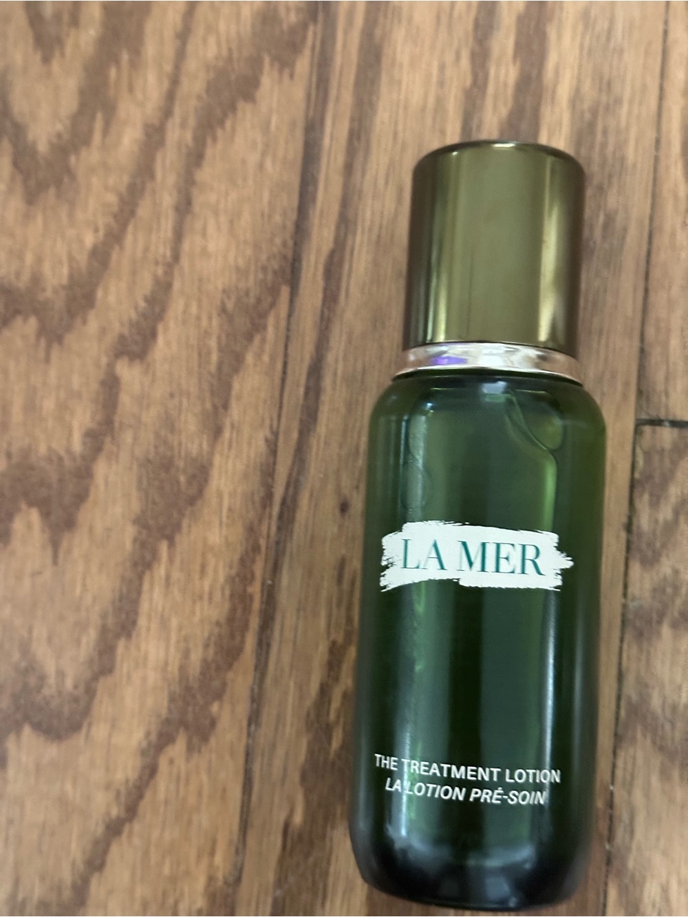 La Mer Green and Gold Treatment Lotion Bottle